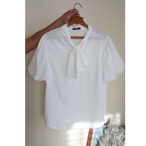 White blouse with ribbon at the top